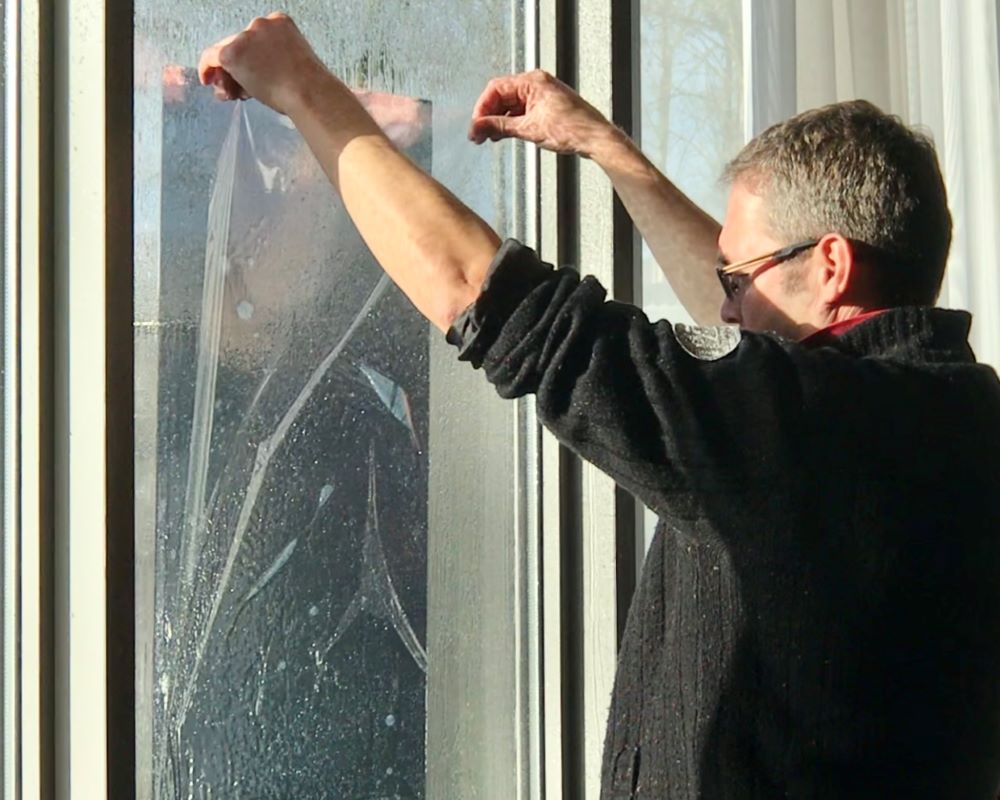 Trainer hangt raamfolie op glaswerk als demo tijdens Appcademy Architectural Windowfilm cursus