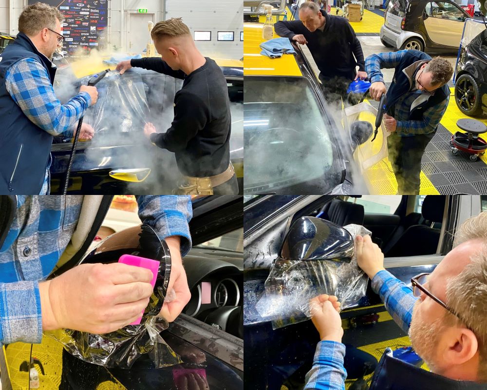 Trainer en cursist plakken PPF op buitenspiegels tijdens Appcademy Paint Protection Film workshop