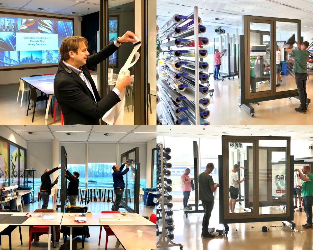 Cursisten doen praktijkoefeningen in trainingsruimte vol met kozijnopstellingen tijdens “Schilderen met folie” Facadefilm workshop